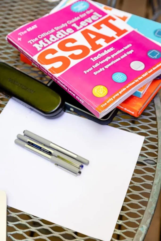 A book and pens on a tutor's desk